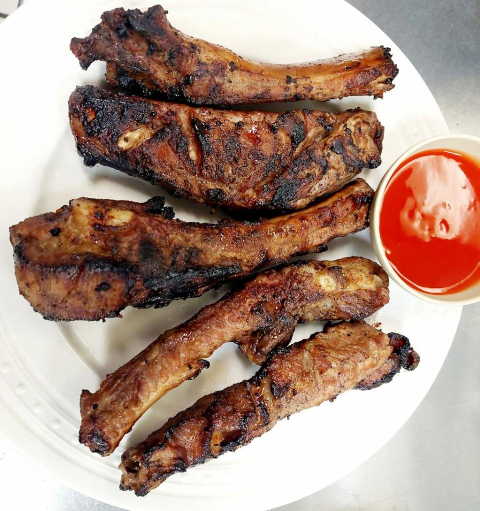 Grilled Pork Ribs · 5 marinated pork spare ribs char grilled.