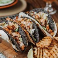 Cajun Fish Tacos · Three crispy corn tortillas wrapped in soft flour tortillas, blackened cod, pepper jack chee...
