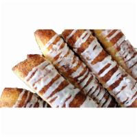 Cinnamon Sugar Breadsticks · Our signature dough covered in cinnamon and sugar baked to perfection and drizzled with
icin...