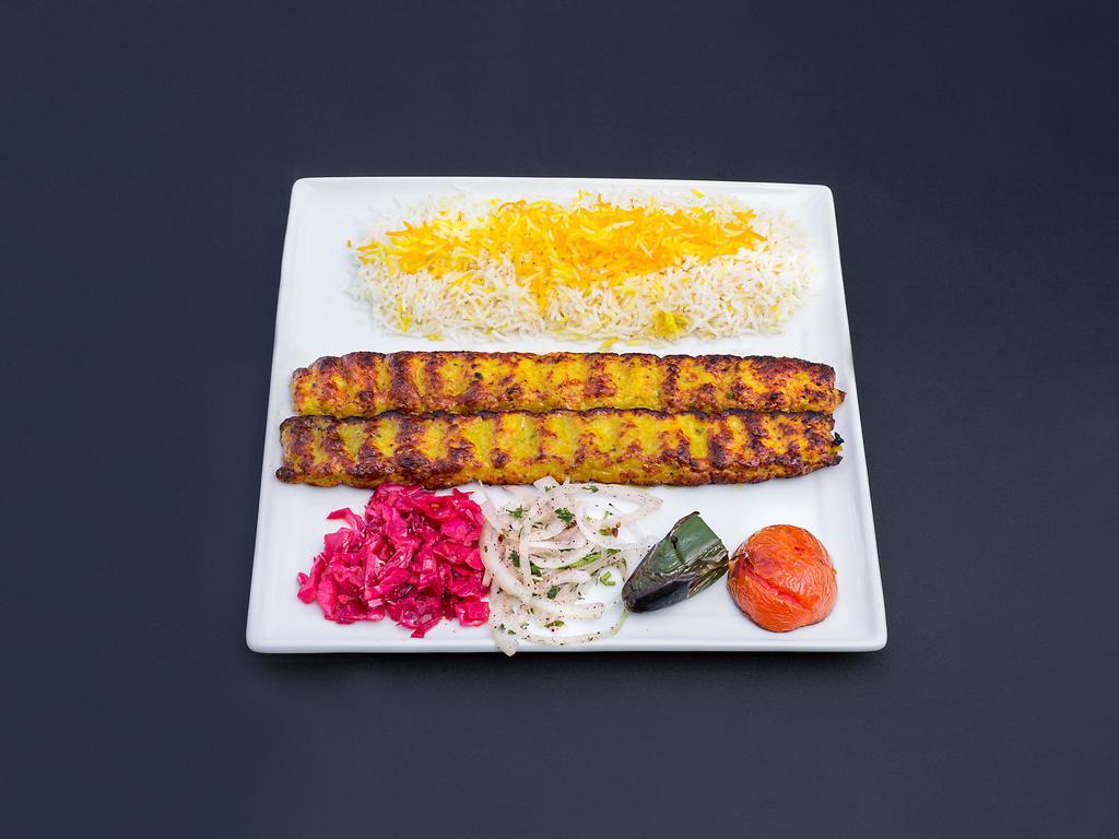 Chicken Koodideh · Spicy ground chicken skewers served with basmati rice and a side of grilled vegtables.