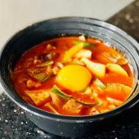 Soon-Tofu · Spicy silken tofu stew with egg yolk, choose from beef, seafood, kimchi, or mushroom.