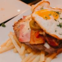 Chivito al Plato · Thin slice of New York strip steak topped with ham, melted mozzarella, bacon, fried egg, pic...
