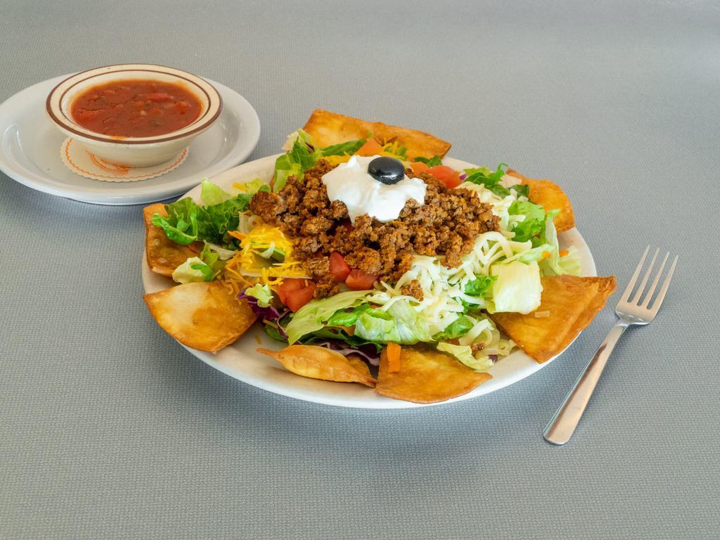 Taco Salad · Ground beef, tomato, shredded cheddar, and Jack cheese and sour cream, served with crispy flour tortilla chips and salsa.