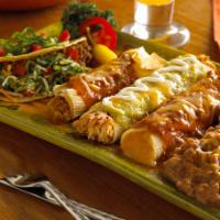 Juarez · Crispy beef taco, tamale, chicken enchilada and cheese enchilada.   Served with refried bean...