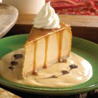 Dulce De Leche Cheesecake · Caramel flavored cheesecake garnished with caramel and chocolate syrup.