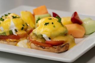 Eggs Benedict · Two poached eggs with canadian bacon topped with hollandaise sauce served on an English muffin with home fries