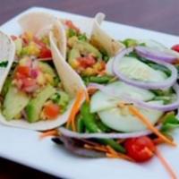 Fish Tacos · Two soft shell tacos filled with mahi mahi, cilantro mayo, avocado, shredded lettuce, corn, ...