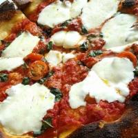 Regina Margherita Pizza · Fresh torn basil, fresh mozzarella and heirloom cherry tomatoes with tomato sauce.