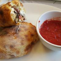 Calzone · Filled with ricotta, mozzarella, scamorza (smoked provolone). Tomato sauce served on the side.