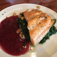 Salmone alla Piccolo · Grilled salmon over sauteed cannellini beans and spinach in a port wine reduction.