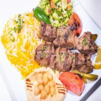 Lamb Shish Kabab · Skewers of Lamb tenderloin, onions and tomatoes and garlic sauce. Served with rice, salad an...