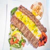 Iraqi Kabab · Skewers of ground lamb with onions and parsley, seasoned and charbroiled. Served with rice, ...