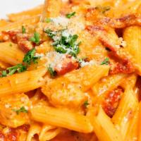 Romano's Pasta · Penne pasta, grilled chicken, artichoke hearts and sun-dried tomatoes tossed with creamy mar...