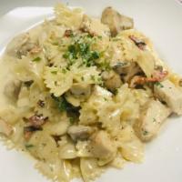 Chicken Bowtie · Bowtie pasta with grilled chicken, mushrooms and sun-dried tomatoes in roasted garlic cream ...