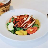 Cajun Chicken Salad · Spicy blackened chicken breast served on top of romaine and iceberg lettuce with tomatoes, o...