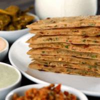 Aloo Paratha · Whole wheat bread stuffed with potatoes, layered with butter and baked in a tandoor oven.