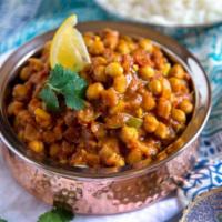 Chana Masala · Chickpeas cooked with onions, tomatoes, Indian herbs and spices.