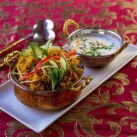 Goat Biryani · Long grain aromatic basmati rice cooked with bone-in goat meat. Flavored with Indian herbs a...