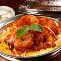 Shrimp Biryani · Long grain aromatic basmati rice cooked with jumbo shrimp. Flavored with Indian herbs and sp...