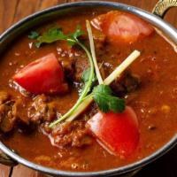 Chicken Curry · Chicken cooked with onions, tomatoes and Indian herbs and spices.