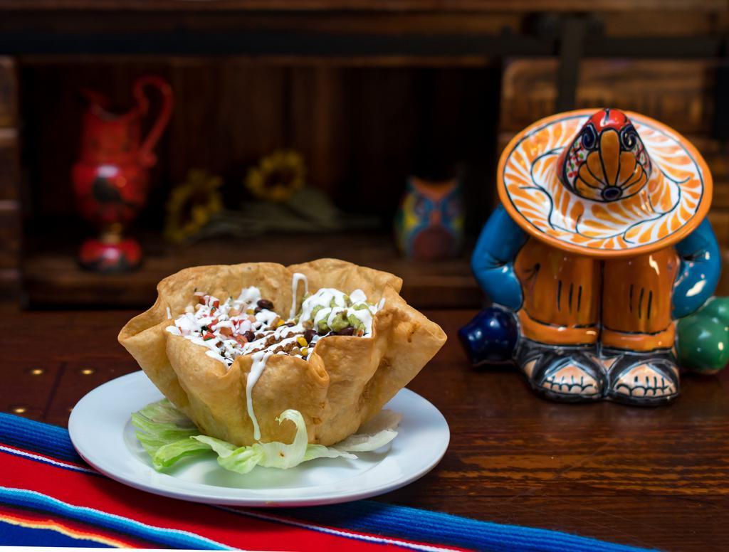 Ensalada de Taco · Taco salad. Fresh cheese, mixed veggies, black beans, pico de gallo, shredded lettuce, sour cream, guacamole, crispy flour tortilla.