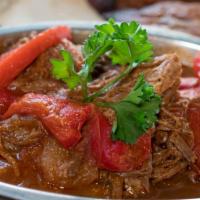 Ropa Vieja · Shredded beef. Shredded beef cooked in tomato sauce, bay leaves, onions, garlic, peppers. Se...