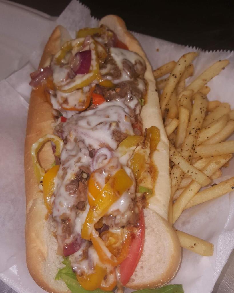 4. That Philly Tho! Brisket  · Sauteed onions and garlic, banana peppers, baby bell peppers (none of those green), Boss sauce, provolone, romaine, and tomato served on a Cellone's hoagie bun with a side of Italian aioli and a small fry.