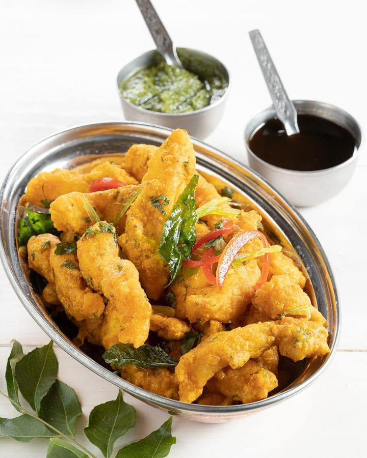 Fish Amritsari · Flaky Swai fish friend crisp and spiced with chaat masala & dried mango dust served with coriander chutney