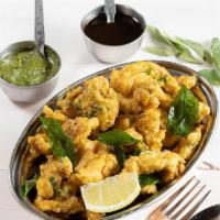 Chicken Pakoras · Golden friend chicken tenders dusted with chef's special masala blend served with cilantro d...