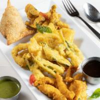 Saffron Sampler · Assorted of Chicken Pakoras, Amritsari fish, vegetable samosa and vegetable pakoras served w...