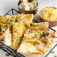 Garlic Cheese Naan · Traditional flat breads cooked in our tandoor clay oven