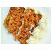 CARROT CAKE · Dark, fruity and moist with walnuts, raisins and cream cheese frosting.