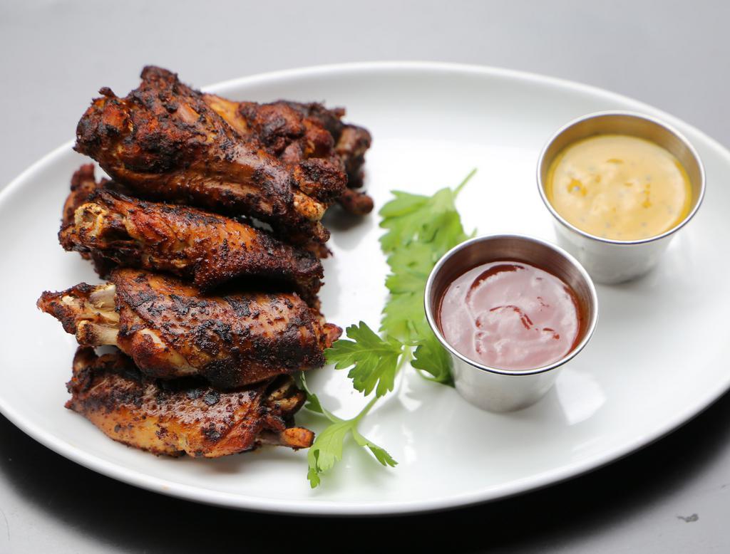 Smoked Chicken Wings · Grilled chili-rubbed wings and drummies, BBQ sauce, mustard BBQ sauce