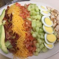 Cobb Salad · Fresh lettuce topped with tomato, onion, cucumber, avocado, hard-boiled egg, bacon, grilled ...