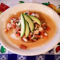 Tostada and Shrimp Ceviche · Shrimp marinated in lime juice, mixed with cilantro, chopped onions and diced tomato. Topped...