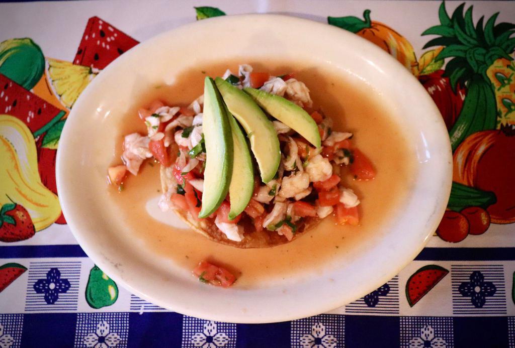 Tostada and Shrimp Ceviche · Shrimp marinated in lime juice, mixed with cilantro, chopped onions and diced tomato. Topped with  avocado slices.