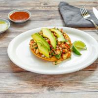Tostada and Fish Ceviche · White fish marinated in lime juice, mixed with cilantro, chopped onions and diced carrots. T...