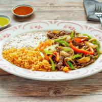 Carnitas de Res · Steak strips cooked and mixed with onions, green bell peppers and tomato. Served with rice a...