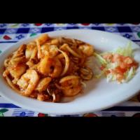 Arroz con Camarones · Tiger shrimp sauteed with mushrooms and onions, served on a bed of rice. Topped with Jack ch...