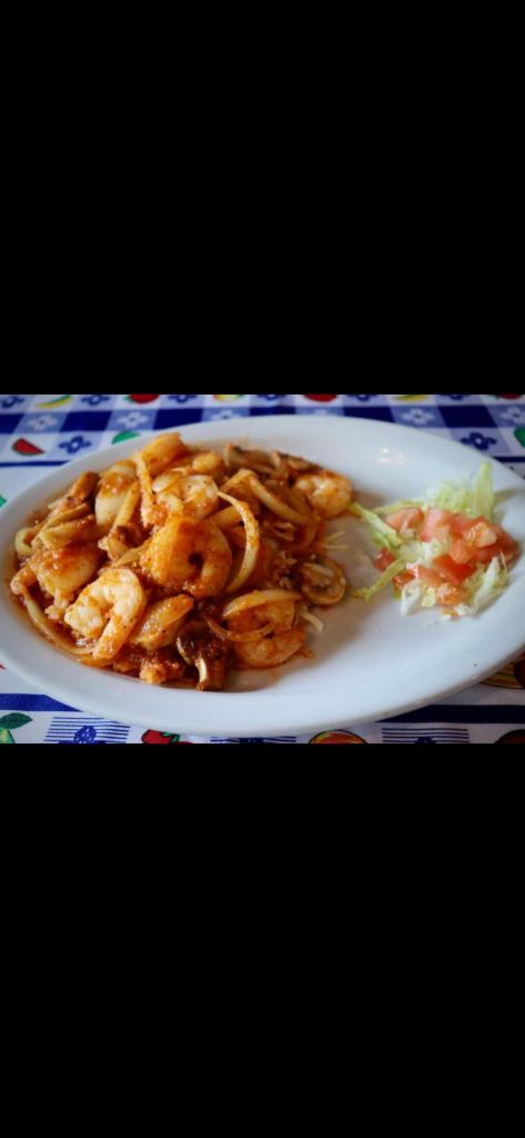 Arroz con Camarones · Tiger shrimp sauteed with mushrooms and onions, served on a bed of rice. Topped with Jack cheese and a side of tortillas.