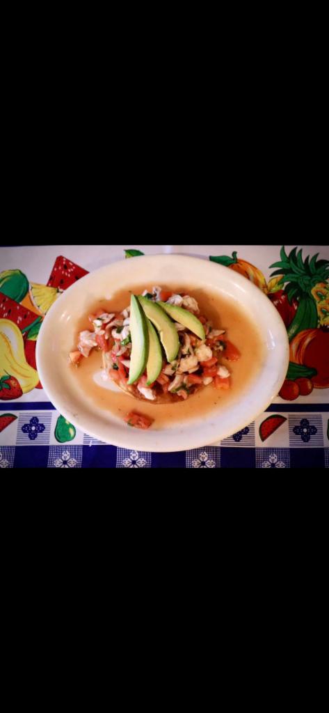 Tostada Shrimp Ceviche · Shrimp marinated in lime juice mixed with cilantro, chopped onions and diced tomato. Topped with avocado slices.