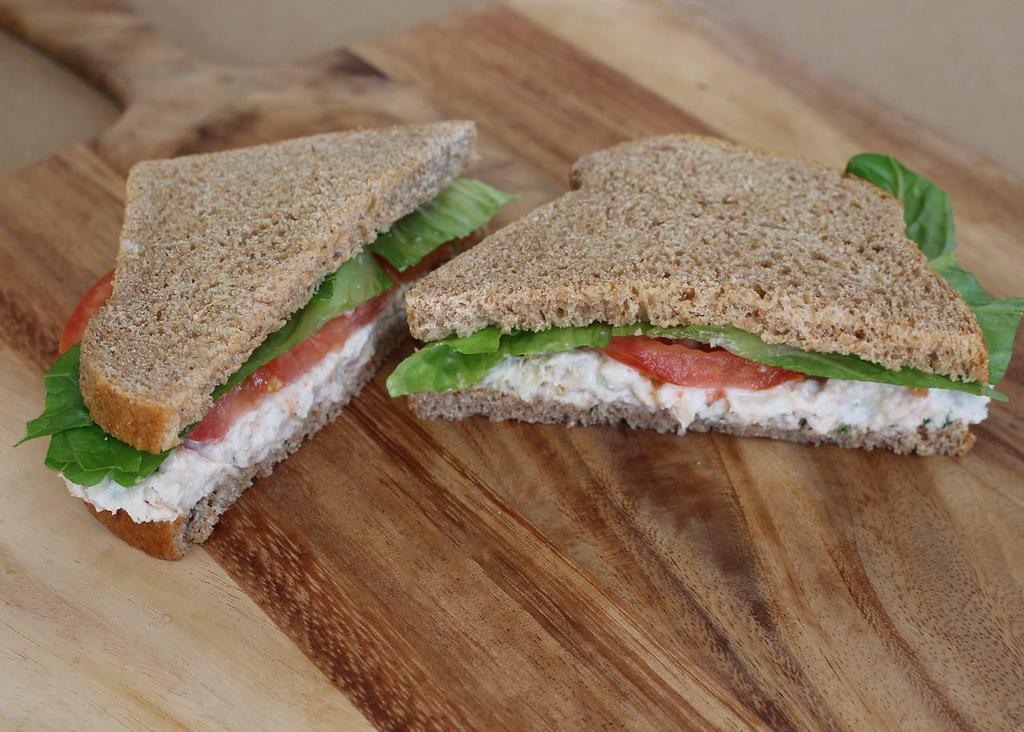 Tasty Tuna Sandwich · All white albacore on our honey whole wheat bread. Made with our own seasoned mayo, topped with lettuce, tomato and red onion.