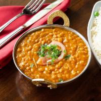 Dal Tarka · Piquant split garbanzo beans cooked with garlic, tomatoes, onions and spices.