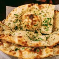Garlic butter Naan · Naan topped with garlic & cilantro and then baked in the clay oven