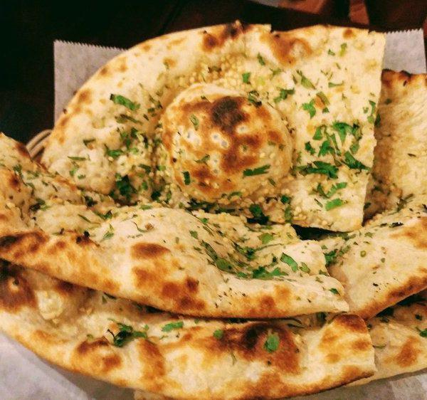 Garlic butter Naan · Naan topped with garlic & cilantro and then baked in the clay oven