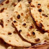 Tandoori Roti · Whole wheat flour bread baked in traditional clay oven.