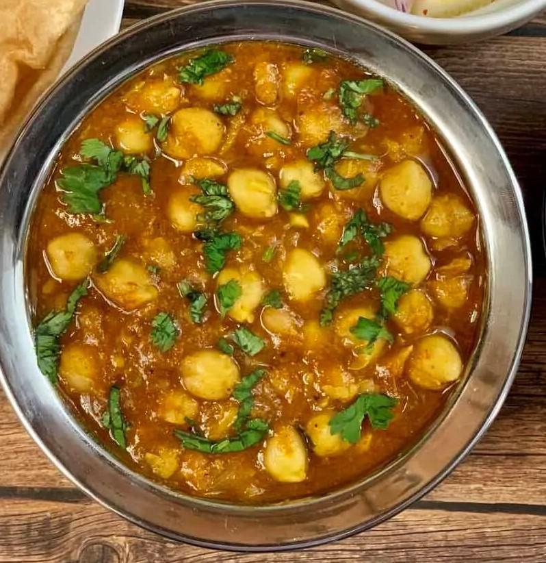 Channa Masala · Chickpeas cooked in onion & tomato sauce with Himalayan herbs & spices.