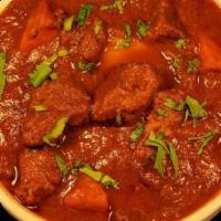 Lamb Vindaloo · Boneless lamb cooked with potato in onion and tomato gravy with the touch of vinegar mixed t...