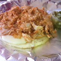 Pollona · Shredded chicken served as topping on a grilled Colombian arepa with mozzarella cheese.