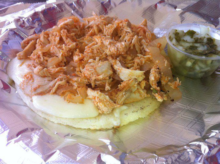 Pollona · Shredded chicken served as topping on a grilled Colombian arepa with mozzarella cheese.